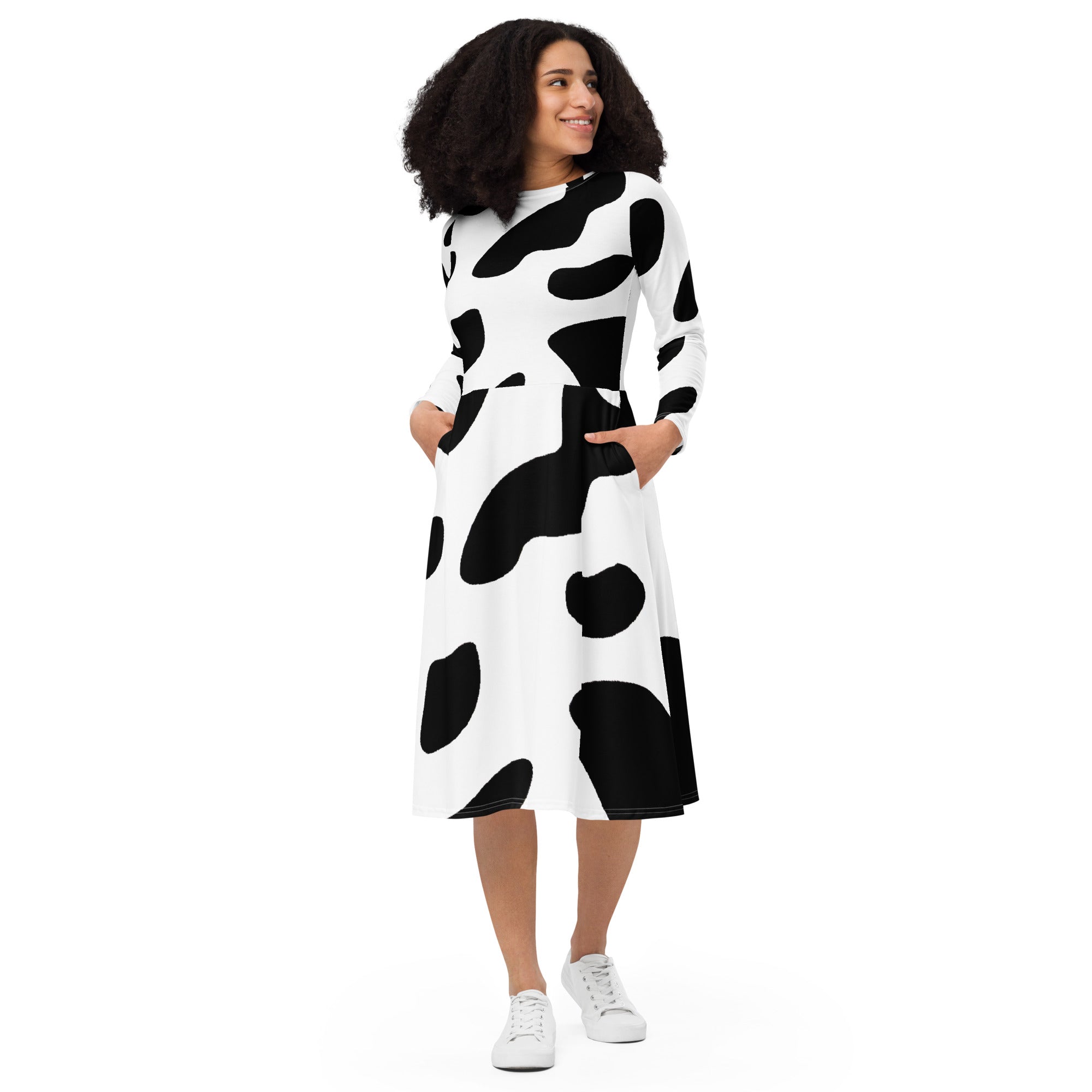 Womens Long Sleeve Midi Dress featuring a stylish black and white cow print, showcasing a fitted waist and flared bottom with side pockets.