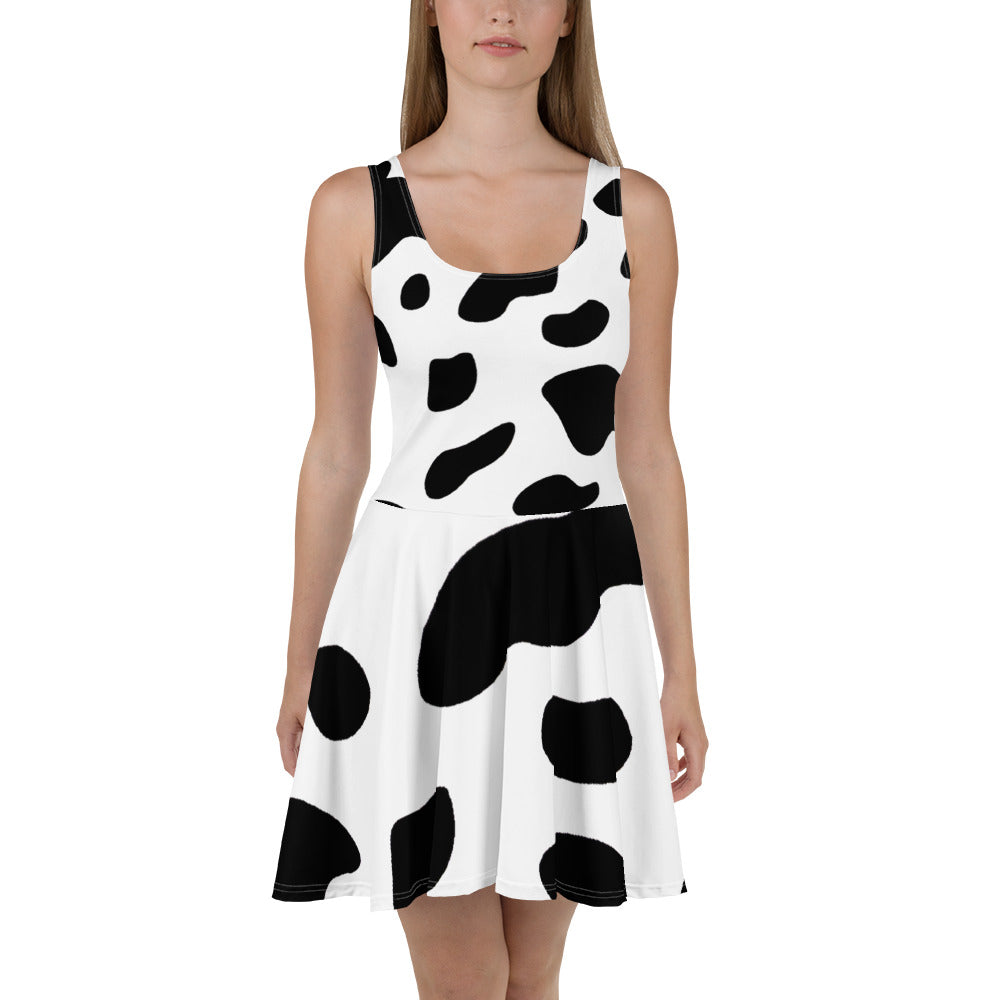 A stylish women's skater dress featuring a black and white cow print design, showcasing a flattering A-line silhouette and sleeveless style.