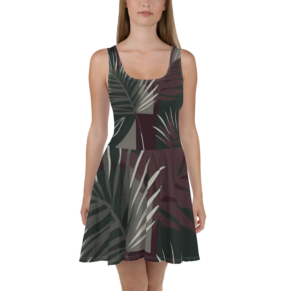 Women's skater dress featuring palm tree leaves design on a maroon green background, showcasing a flattering A-line silhouette.