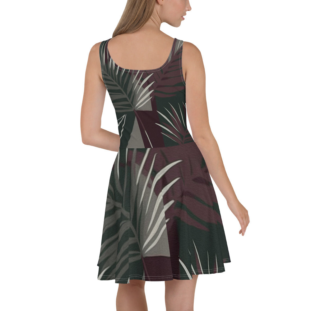 Women's skater dress featuring palm tree leaves design on a maroon green background, showcasing a flattering A-line silhouette.