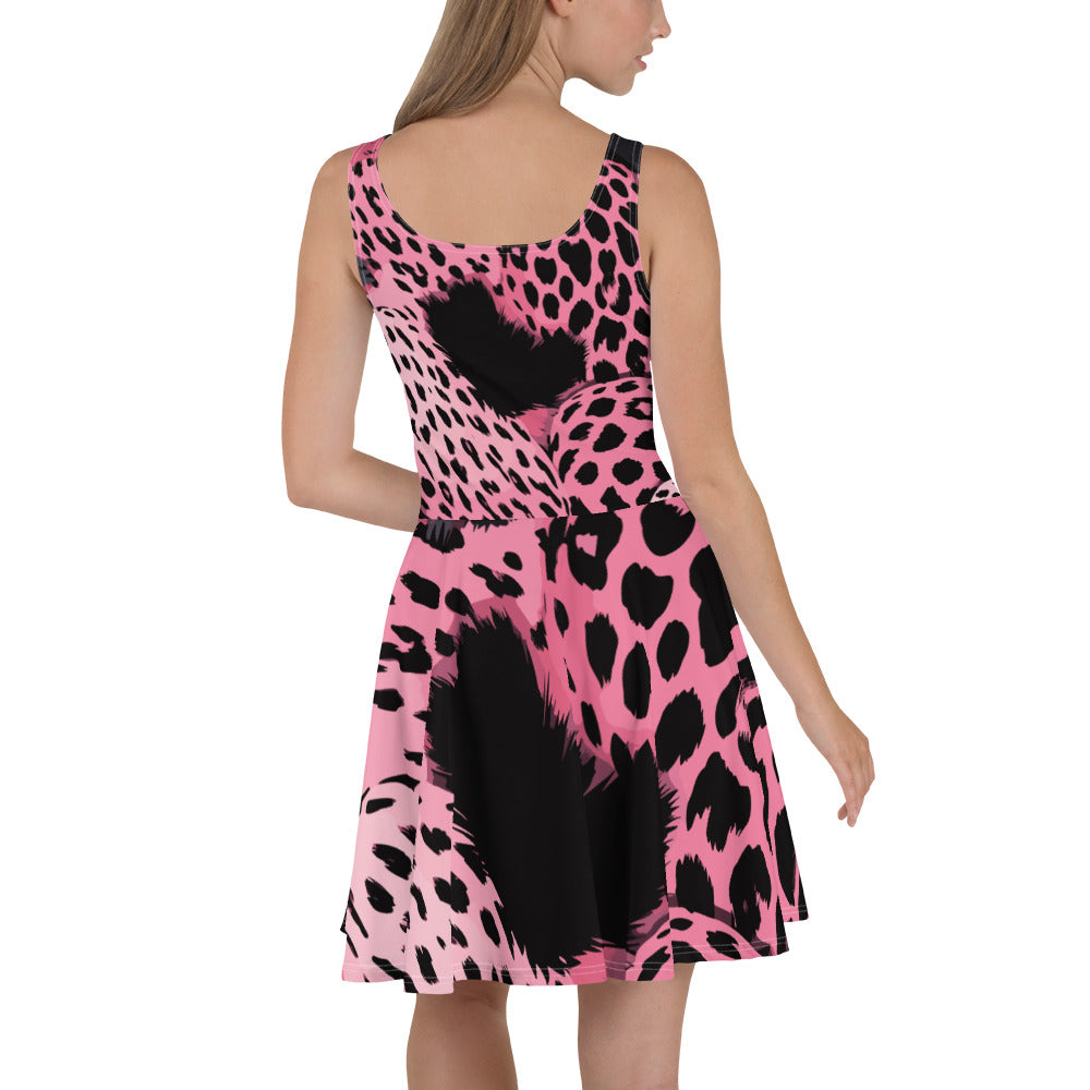 A stylish women's skater dress featuring a pink and black spotted print, showcasing a flattering A-line silhouette and sleeveless design.