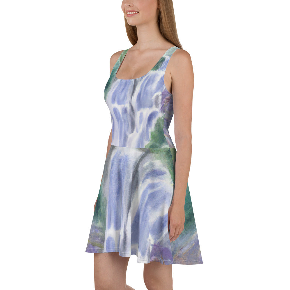 A stylish women's skater dress featuring a purple watercolor waterfall design with a green landscape, showcasing a flattering A-line silhouette.