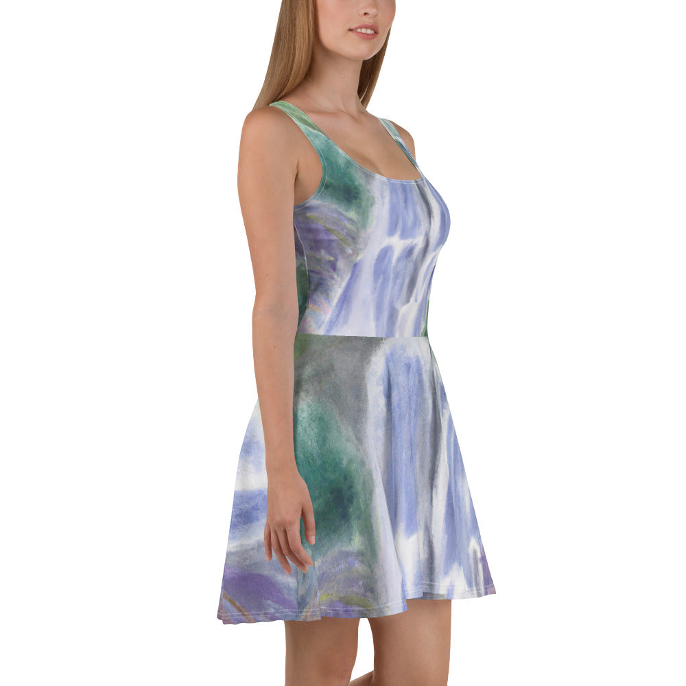 A stylish women's skater dress featuring a purple watercolor waterfall design with a green landscape, showcasing a flattering A-line silhouette.