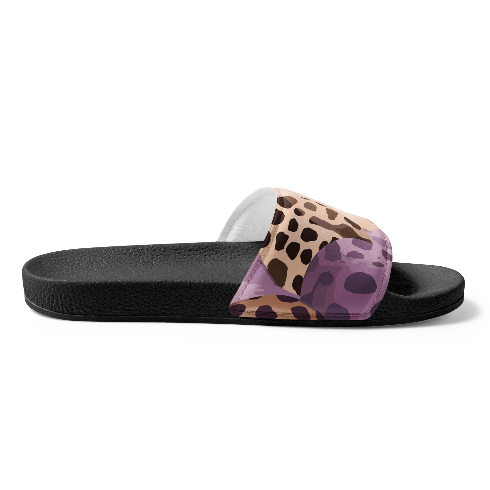 A pair of women's slides featuring a purple lavender and brown spotted illustration, showcasing a cushioned upper strap and textured footbed.