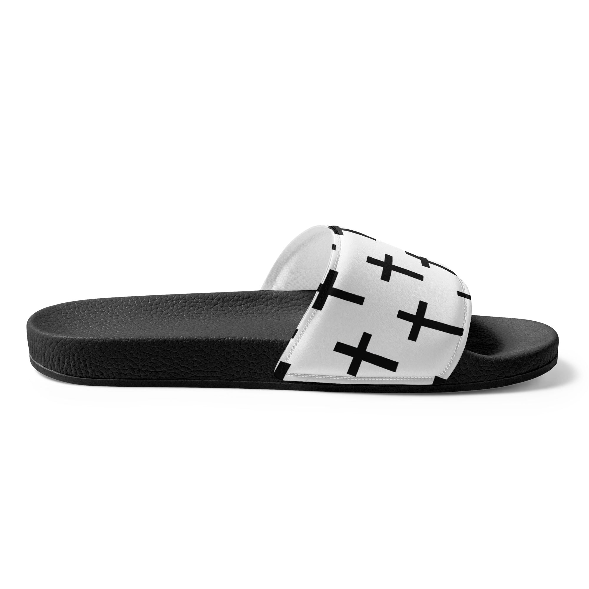 A pair of women's slides featuring a white and black seamless cross pattern, showcasing a cushioned upper strap and textured footbed.