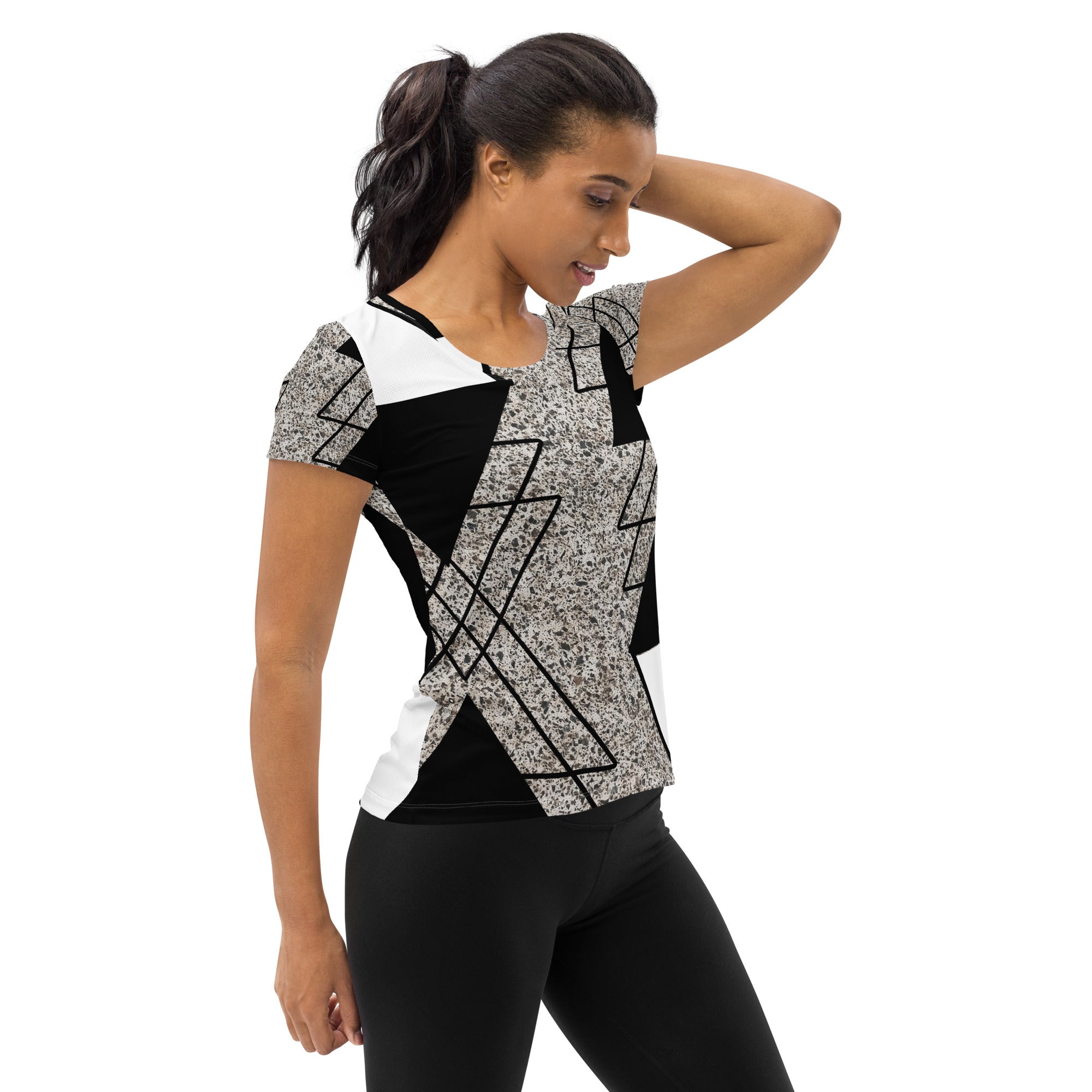 Women's Stretch Fit Athletic Sports T-shirt in black and white with a triangular colorblock design, showcasing its soft fabric and athletic silhouette.