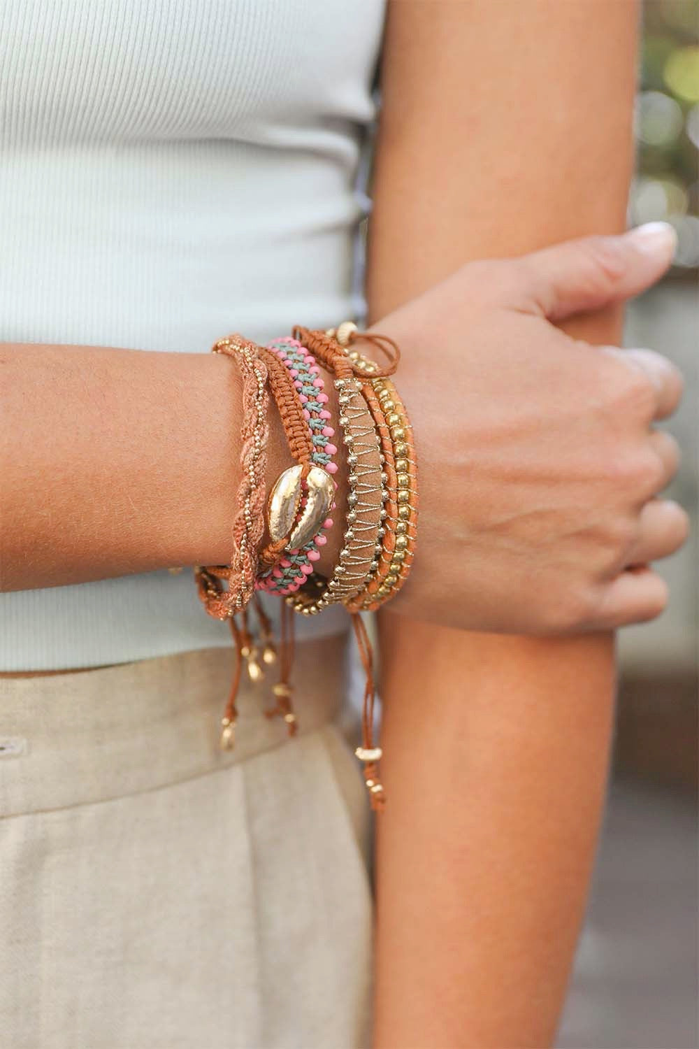 A colorful woven stackable beaded bracelet featuring various bright beads, perfect for layering and adding personality to outfits.