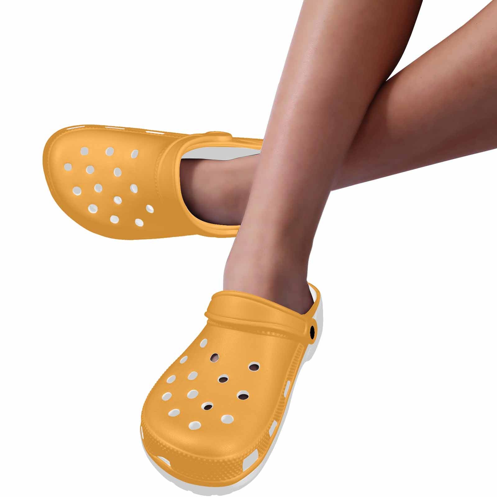 A pair of vibrant yellow-orange adult clogs made from lightweight EVA material, featuring ventilation ports and pivoting heel straps.