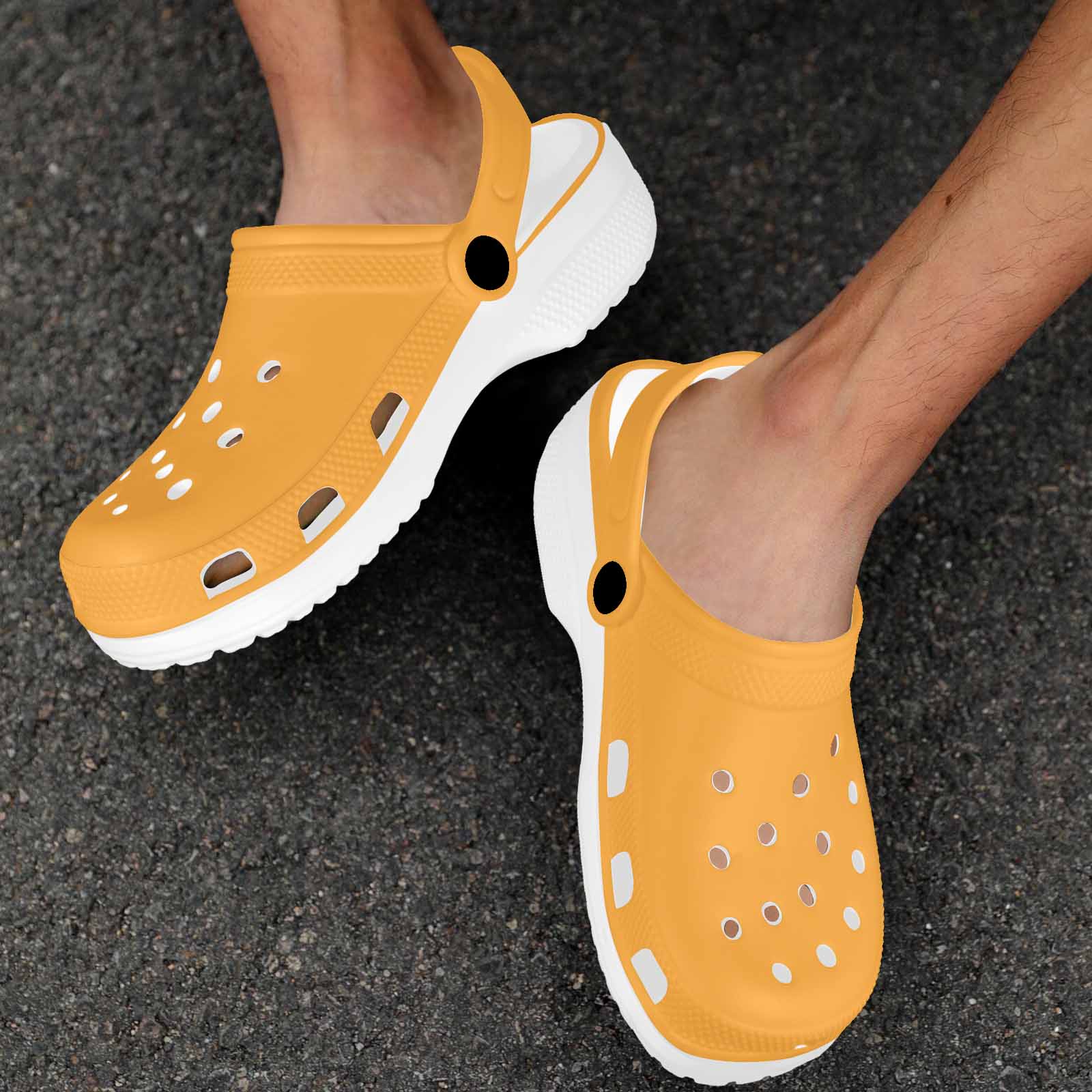 A pair of vibrant yellow-orange adult clogs made from lightweight EVA material, featuring ventilation ports and pivoting heel straps.