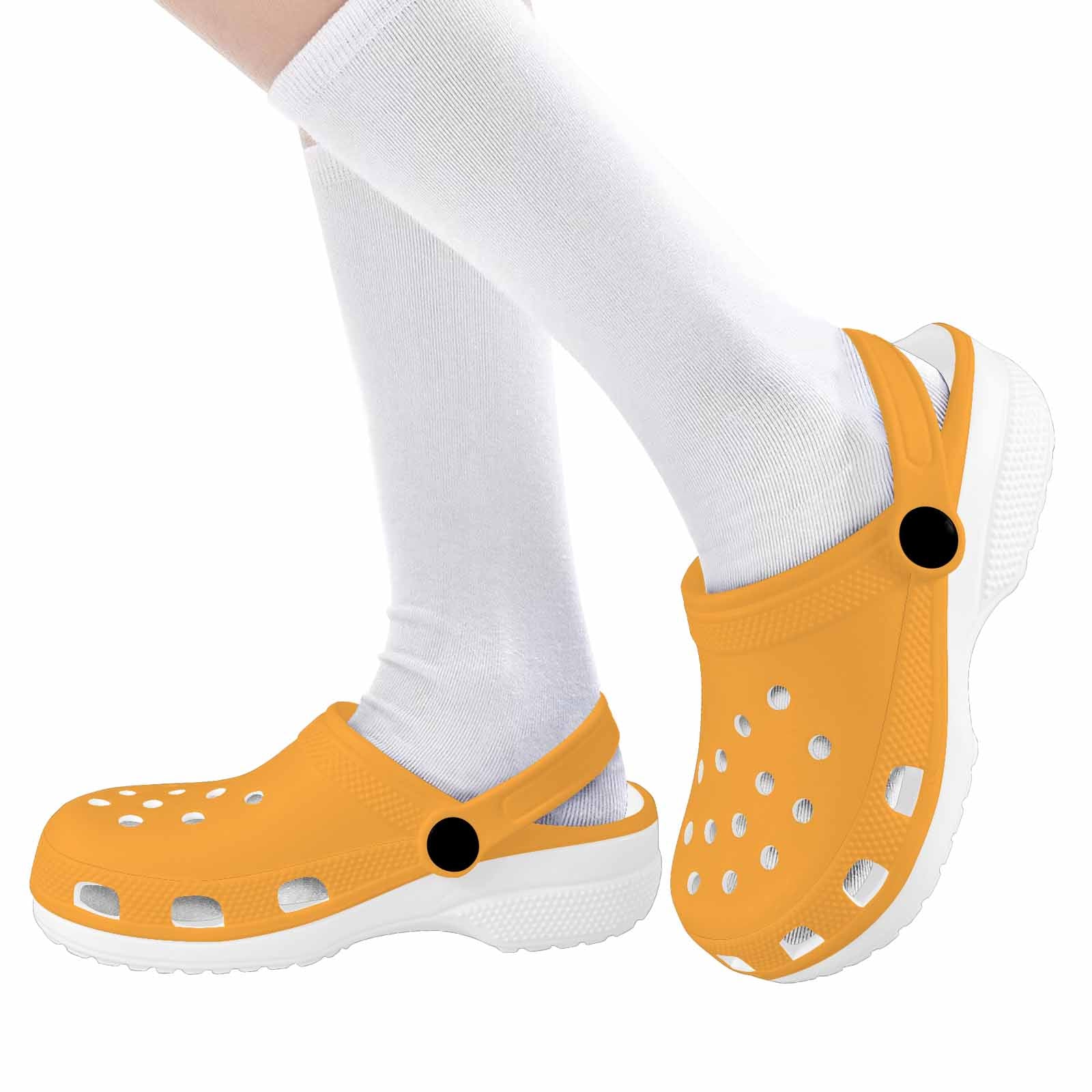 Bright yellow and orange kids clogs made from lightweight EVA material, featuring ventilation ports and pivoting heel straps for a secure fit.