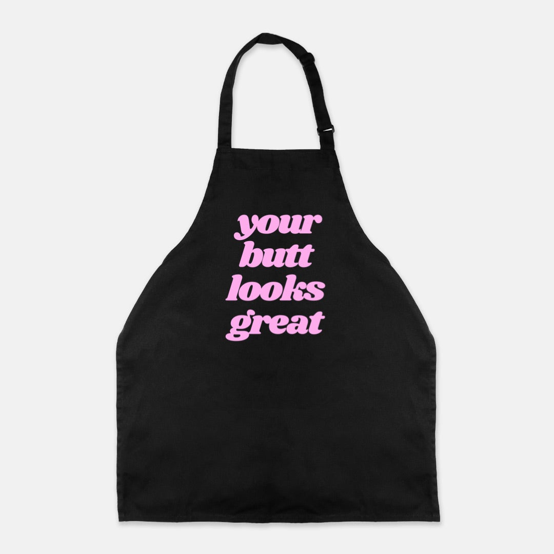 Black apron with adjustable neck strap and long ties featuring the phrase 'Your Butt Looks Great' in a stylish design.