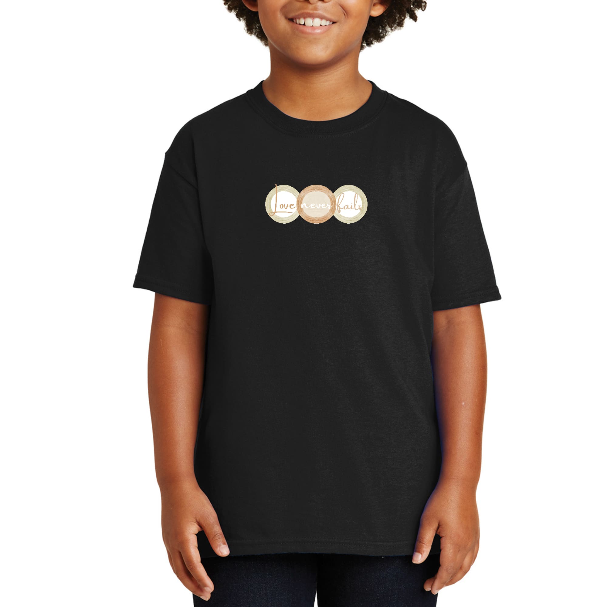 Youth Short Sleeve Graphic T-shirt in pastel brown featuring 'Love Never Fails' design with circular shapes.