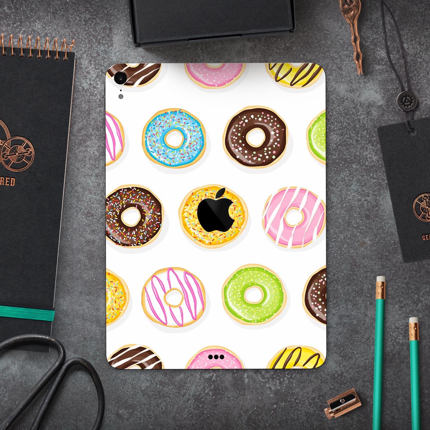 Yummy Colored Donuts Full Body Skin Decal for Apple iPad Pro, showcasing vibrant donut designs on a sleek surface.