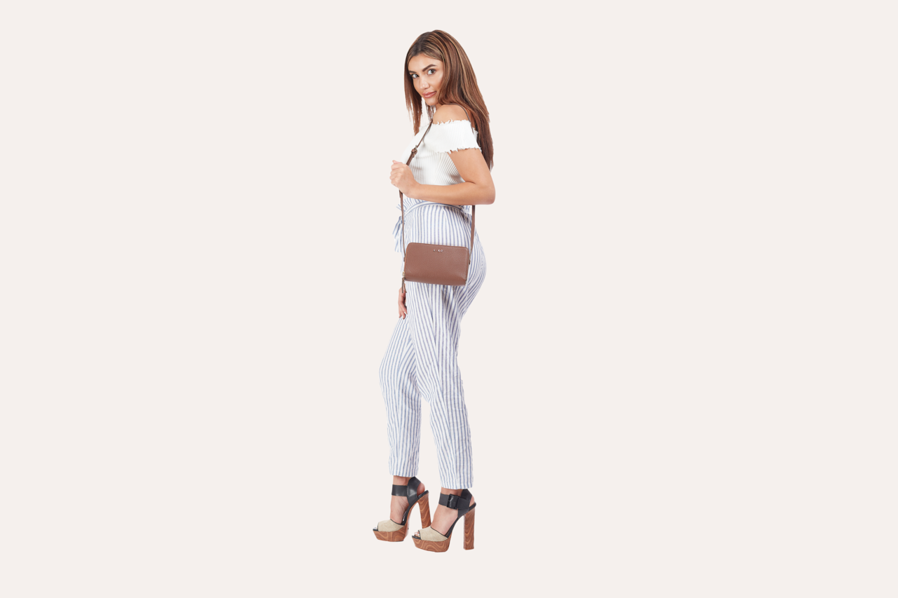 Zip Around Crossbody Pebble bag made of genuine pebble leather, featuring two zipper compartments and an adjustable shoulder strap.