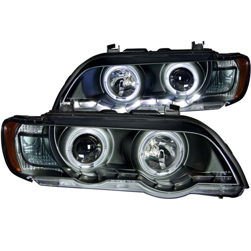 ANZO projector headlights with halo black design for 2000-2003 BMW X5, featuring clear lens and black housing.