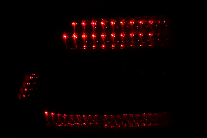 ANZO LED taillights for 2003-2006 Porsche Cayenne with smoke lens, showcasing modern design and bright illumination.