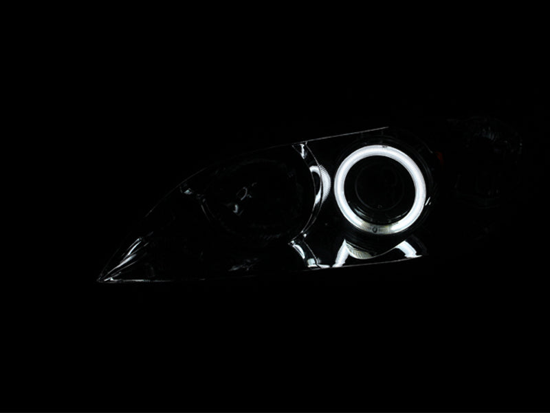 ANZO 2004-2008 Mazda 3 projector headlights with chrome housing and halos, showcasing clear lens design.