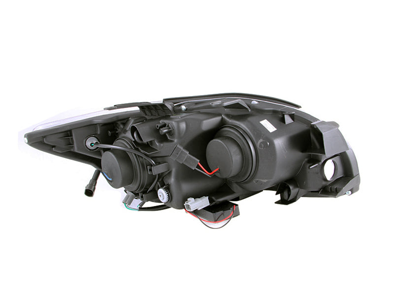 ANZO 2005-2010 Scion tC projector headlights with black housing and halo CCFL rings, showcasing modern automotive lighting design.