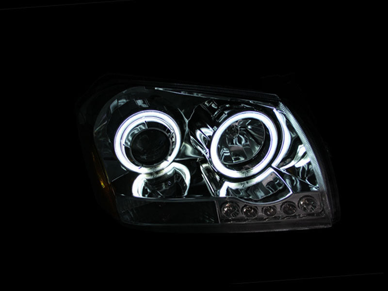 ANZO 2005-2007 Dodge Magnum projector headlights with chrome housing and halo rings, showcasing clear lens design.