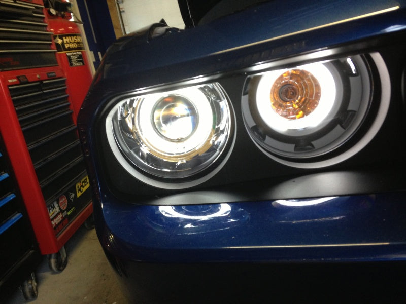 ANZO 2008-2014 Dodge Challenger projector headlights with black housing and halo ring, showcasing modern automotive lighting design.