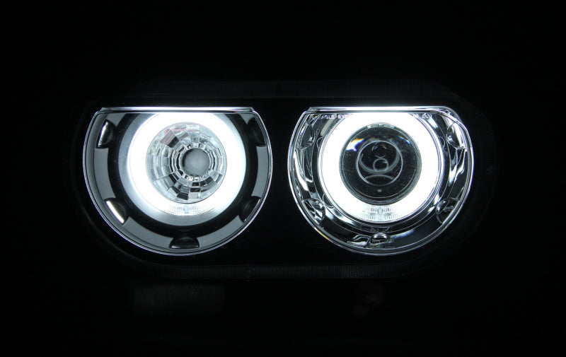 ANZO 2008-2014 Dodge Challenger projector headlights with black housing and halo ring, showcasing modern automotive lighting design.