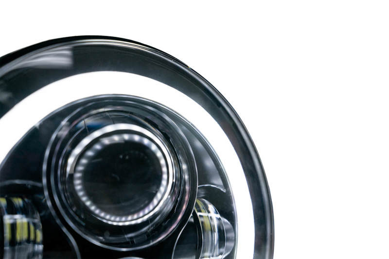 DV8 Offroad LED Projector Headlights for Jeep Wrangler JK with Angel Eye light rings, showcasing bright white light and modern design.