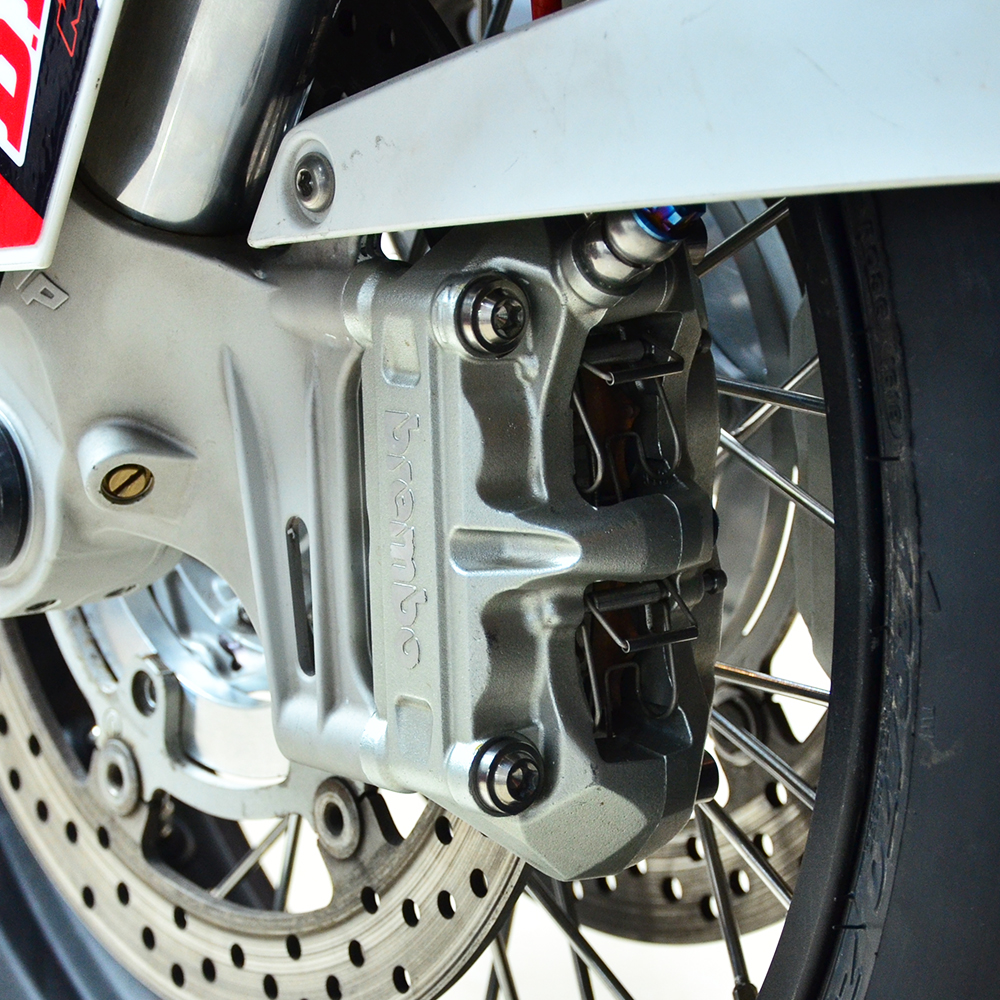 Close-up of motorcycle brake caliper.