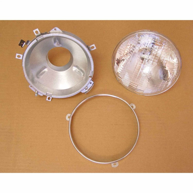 Omix Headlight Assembly with Bulb for 72-86 Jeep CJ models, featuring a headlight bucket, retaining ring, and sealed beam bulb.