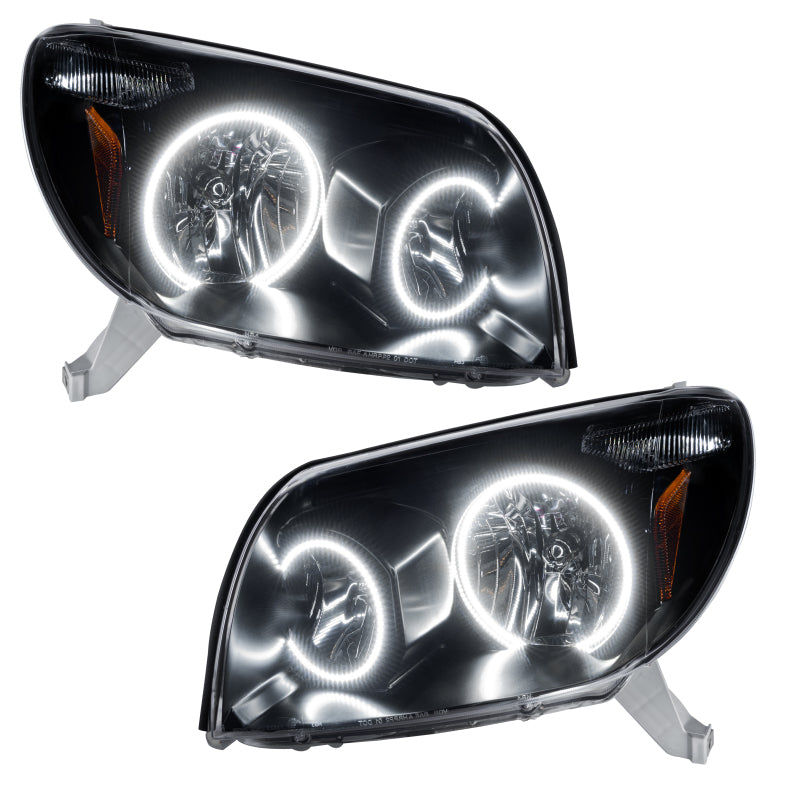 Oracle 03-05 Toyota 4-Runner SMD headlights in black housing with white halo rings, showcasing a sleek design for enhanced visibility.