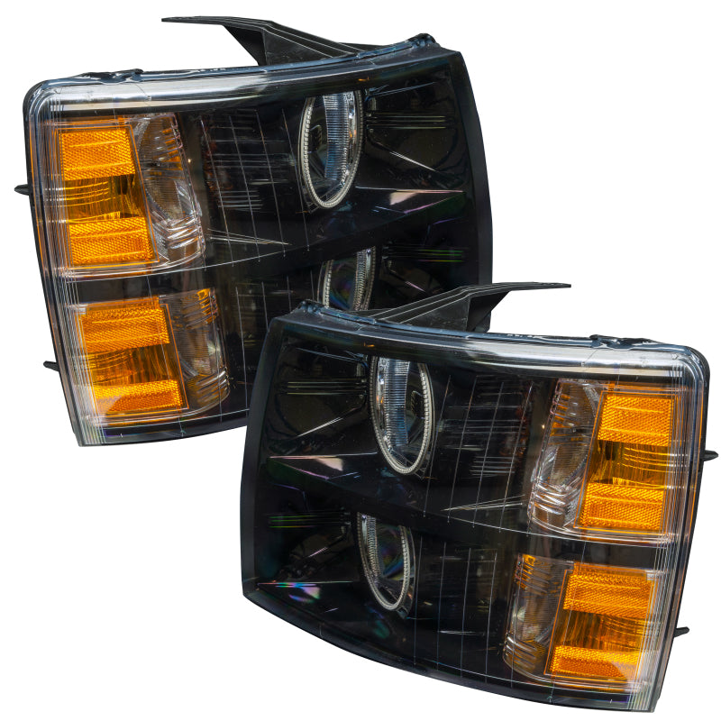 Oracle 07-13 Chevy Silverado SMD headlights in black round style with ColorSHIFT technology, showcasing vibrant LED lights.