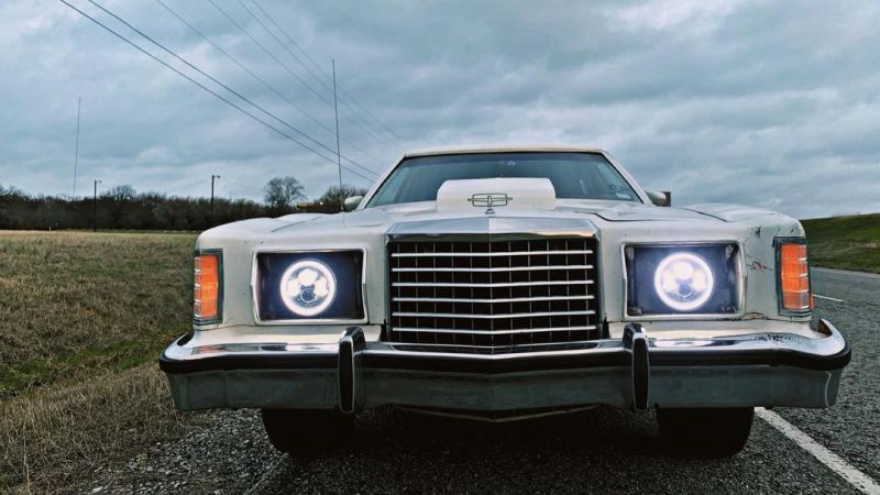 Oracle 7in High Powered LED Headlights with black bezel and white light, showcasing rugged design for Jeep and off-road vehicles.