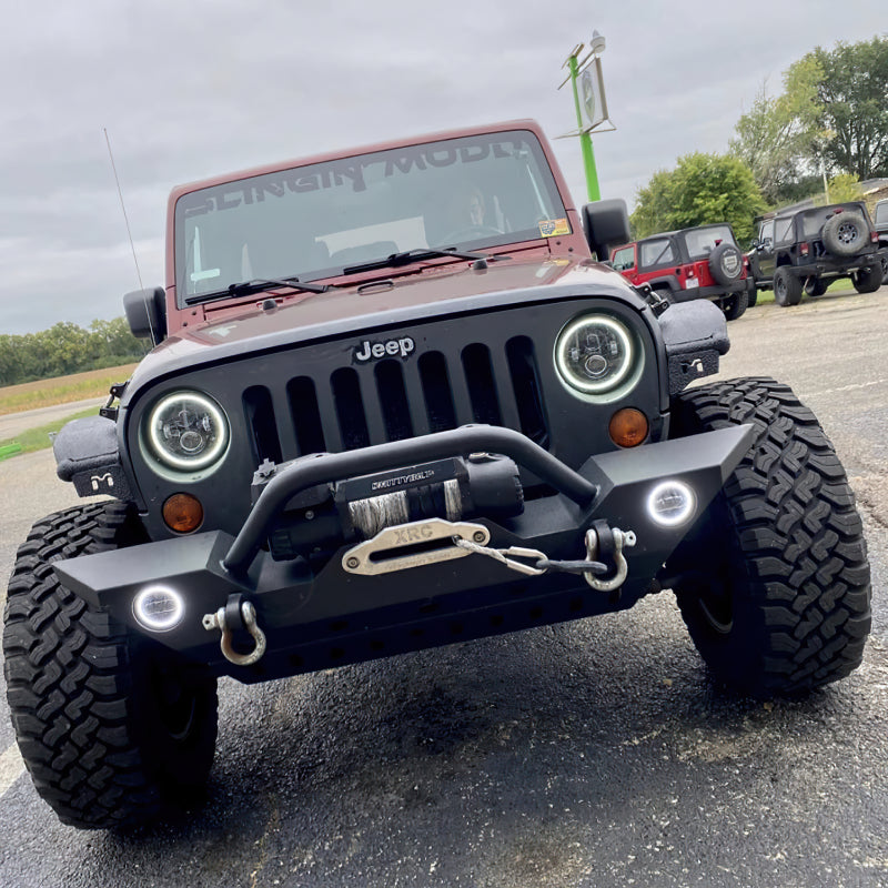 Oracle 7in High Powered LED Headlights with black bezel and white light, showcasing rugged design for Jeep and off-road vehicles.