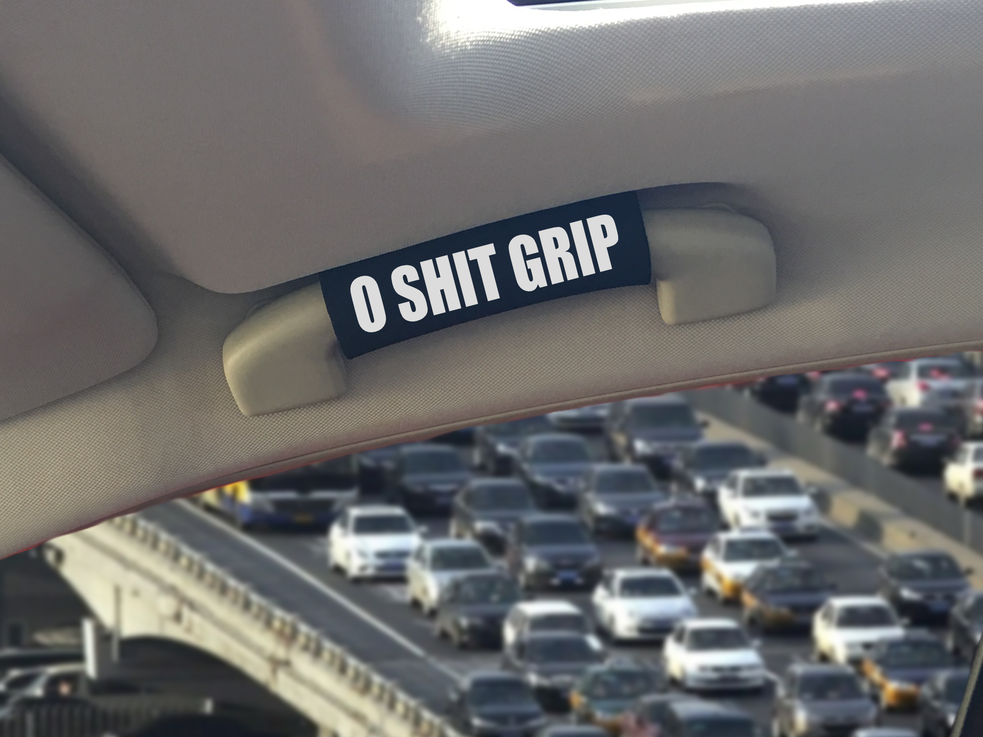 The O Shit Grip® featuring smooth artwork and a super-soft base, available in various colors for a fun vehicle accessory.