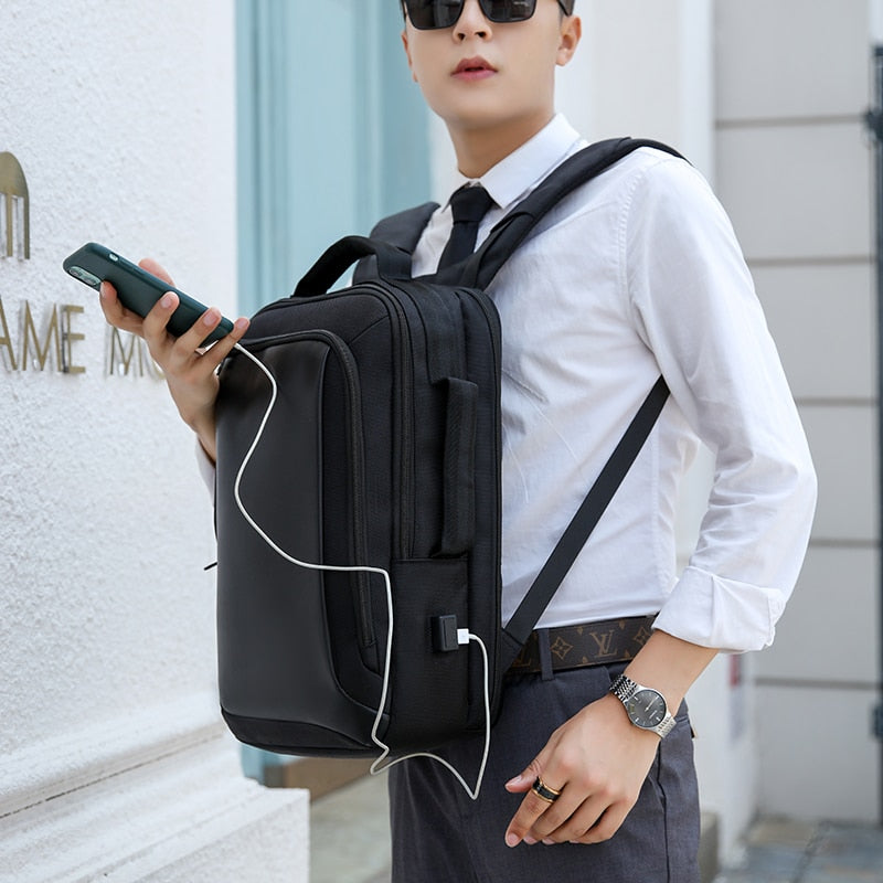 Stylish waterproof backpack for men, designed for laptops up to 15.6 inches, featuring USB charging port and anti-theft design.