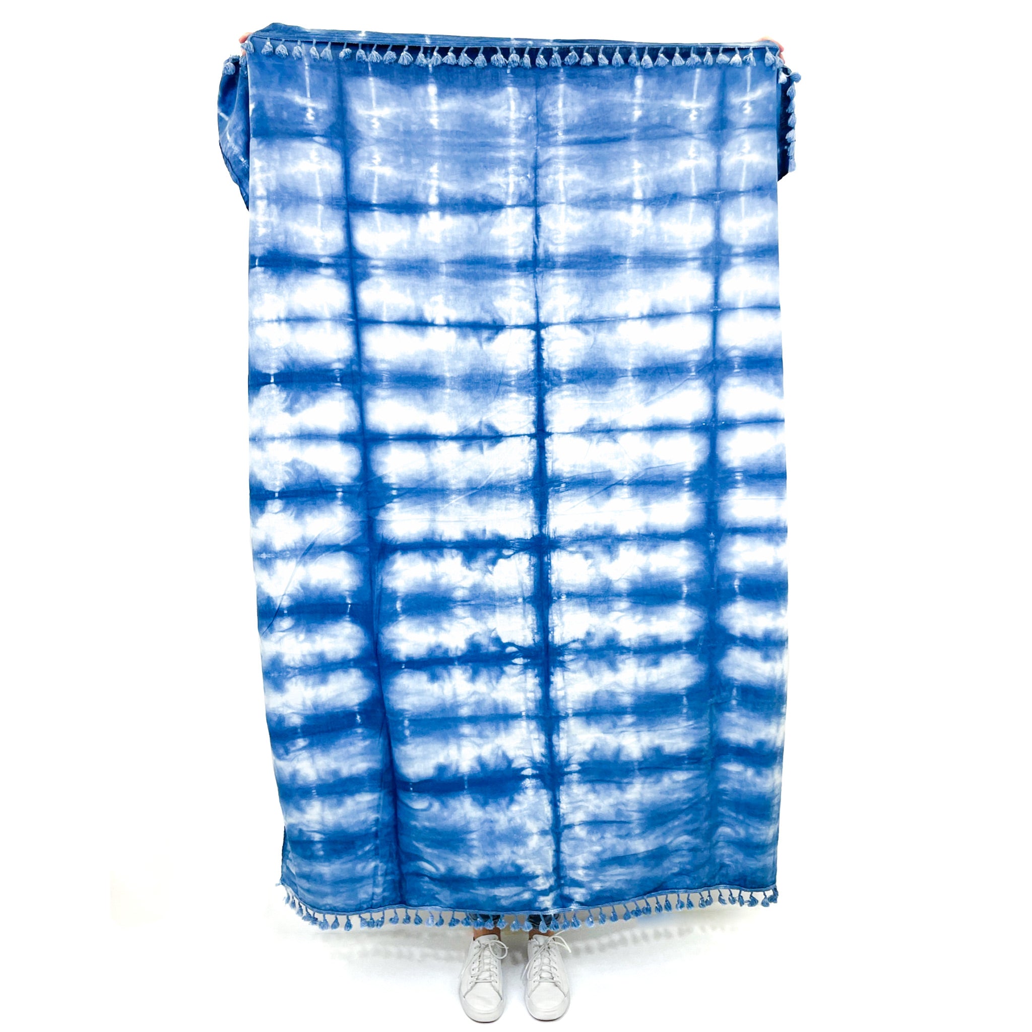 A unique indigo-dyed beach blanket made from soft cotton, showcasing beautiful patterns and vibrant colors, perfect for beach outings or home decor.