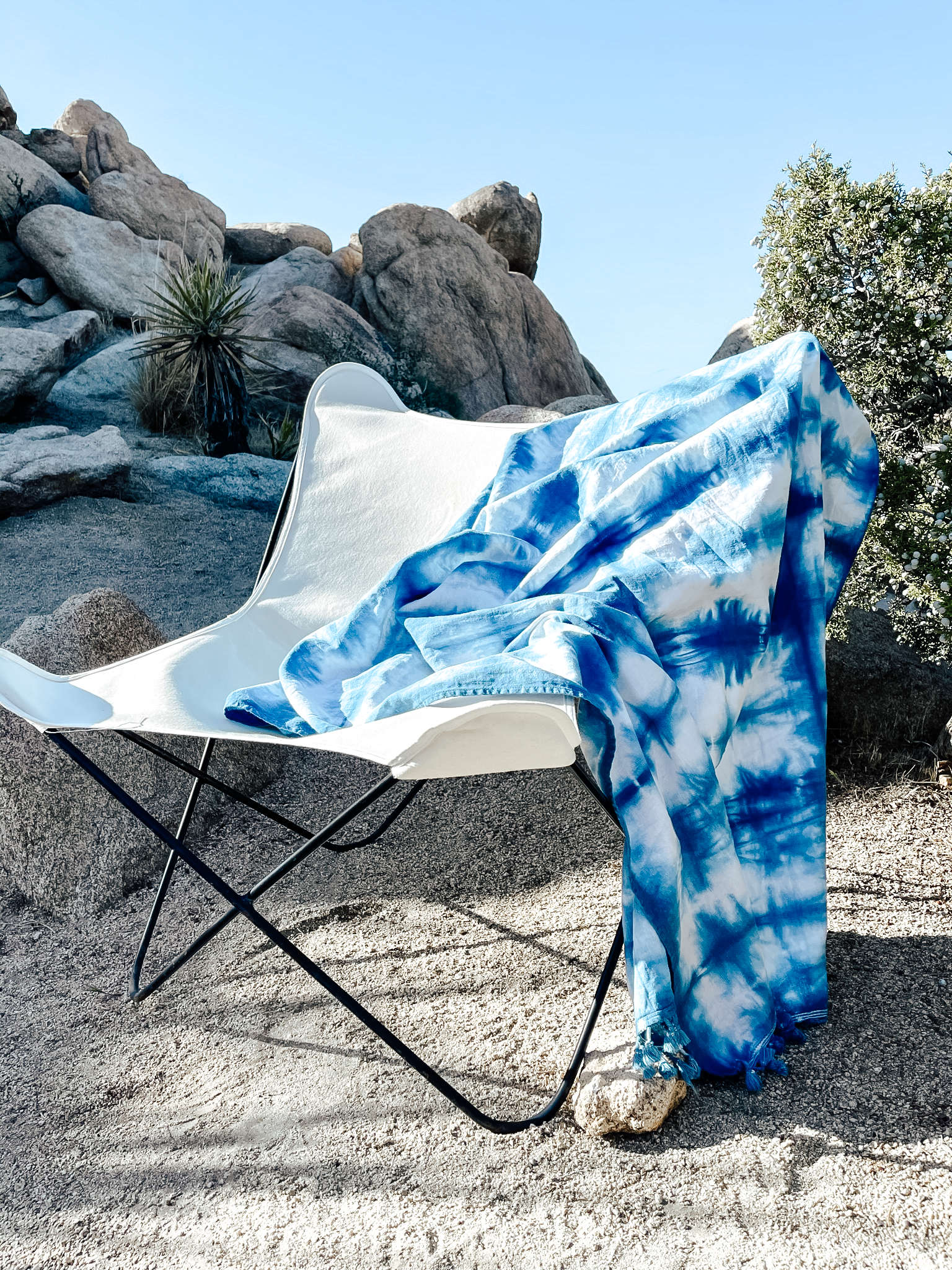 A unique indigo-dyed beach blanket made from soft cotton, showcasing beautiful patterns and vibrant colors, perfect for beach outings or home decor.