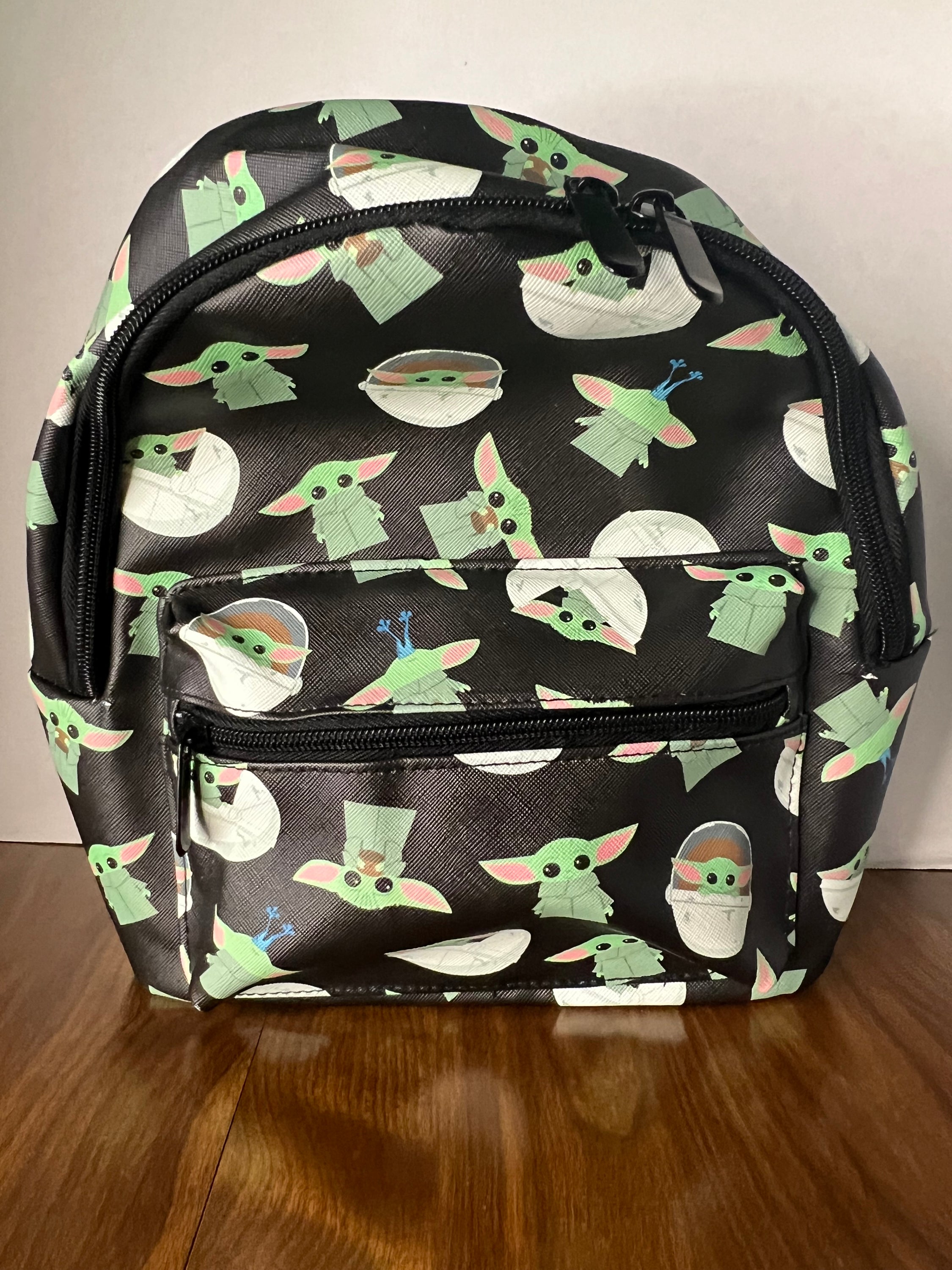 Bioworld Star Wars Grogu Mini Backpack featuring Baby Yoda design, adjustable straps, and zippered pockets.