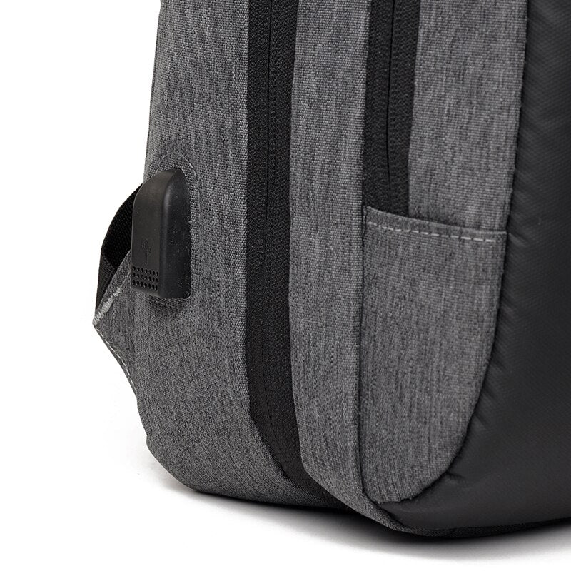 Large-capacity waterproof business backpack for men with USB charging port, featuring a stylish patchwork design and comfortable air cushion belt.