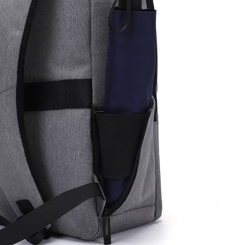 A multifunctional business backpack for men, featuring a USB charging port, waterproof Oxford material, and multiple interior pockets for organization.