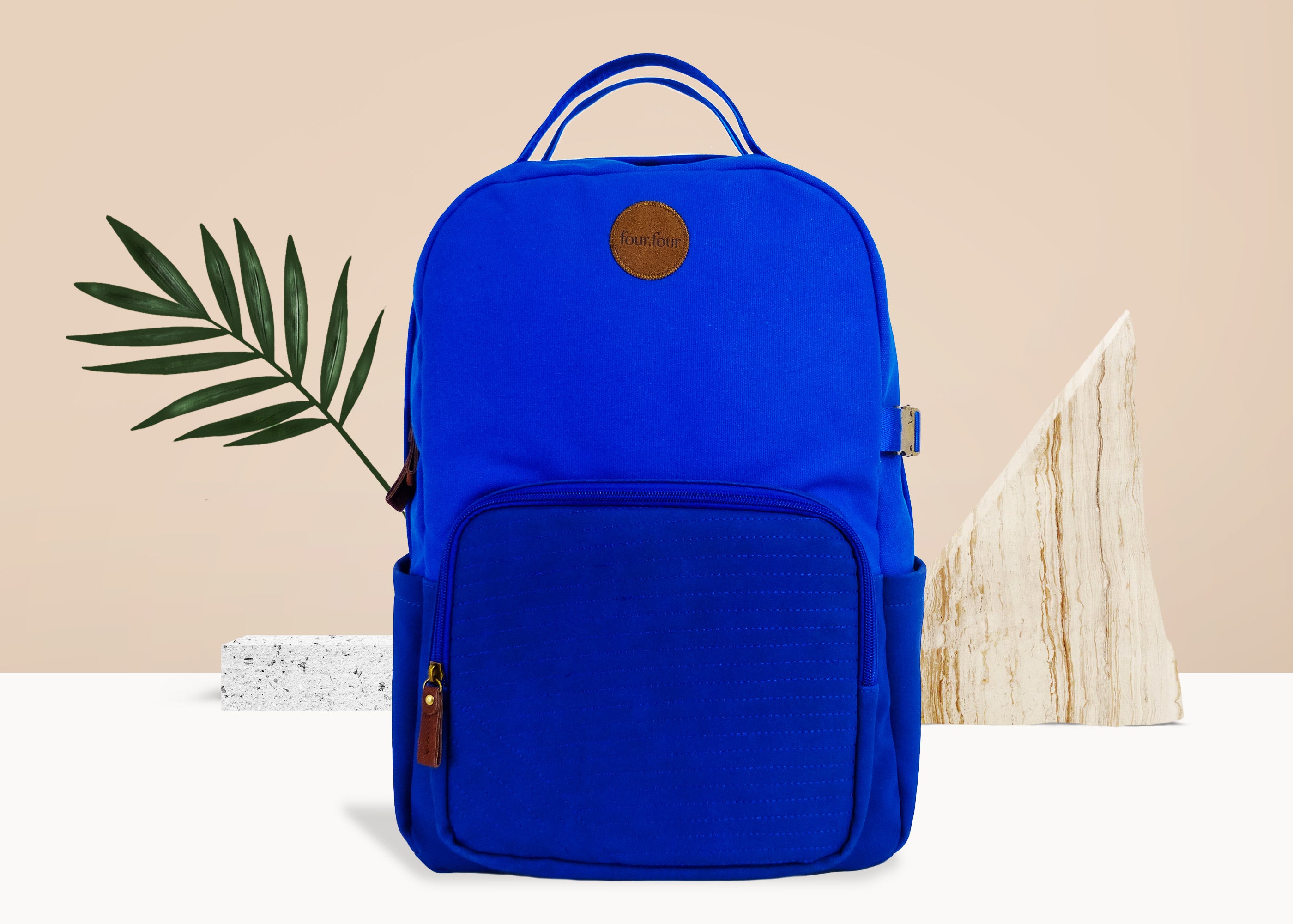 Eternal Optimist Cobalt Blue Backpack featuring a secret back pocket, padded laptop compartment, and eco-friendly materials.