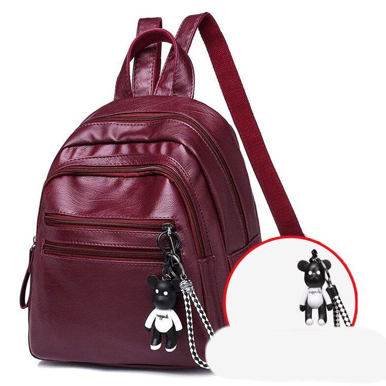 A stylish solid color lady's leather backpack with car suture detailing, perfect for business and casual use.