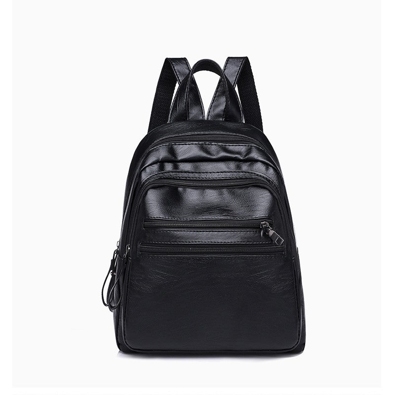 A stylish solid color lady's leather backpack with car suture detailing, perfect for business and casual use.