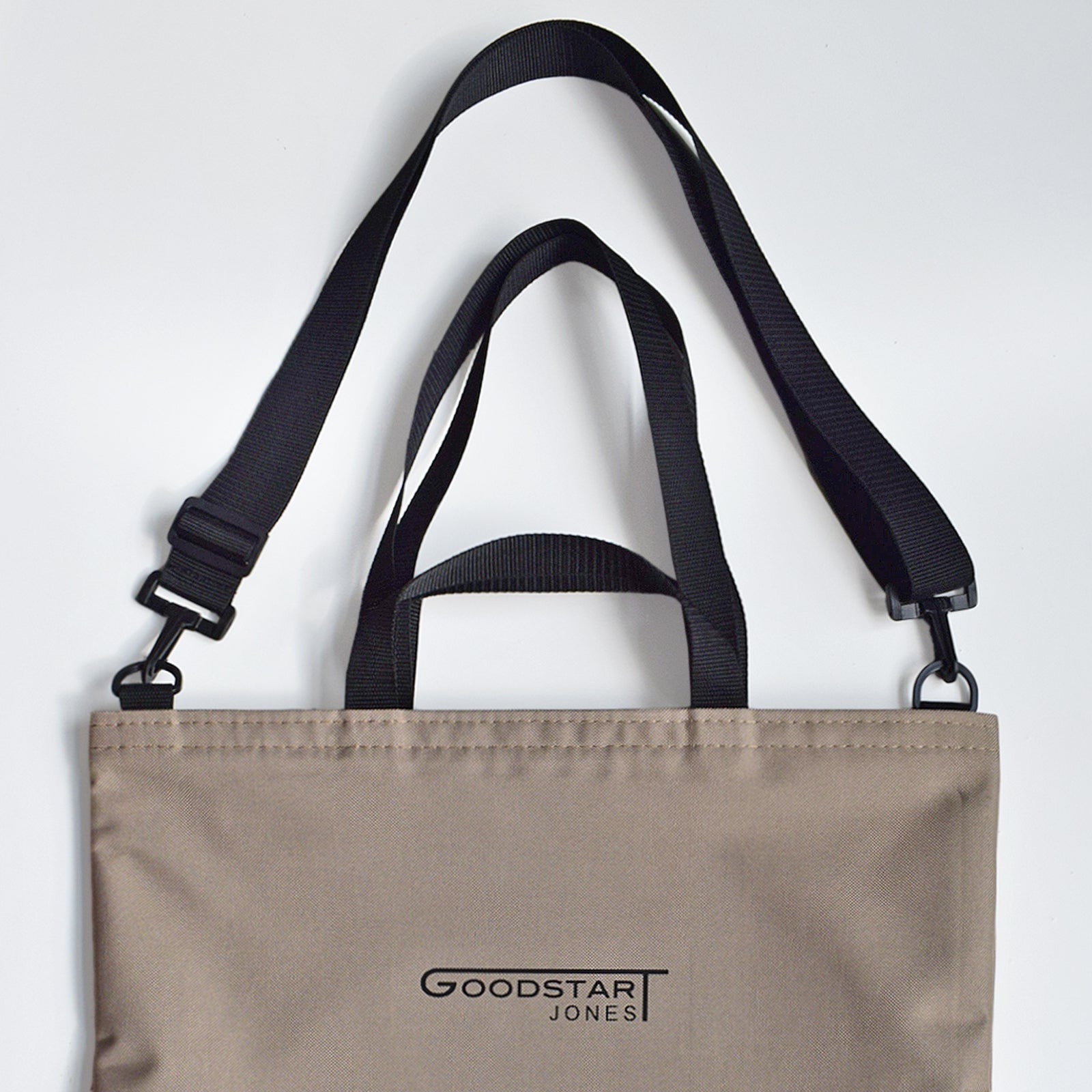 GoodDay Tote Bag in Sand Cream with adjustable shoulder strap and two handles, showcasing its spacious interior and water-resistant exterior.