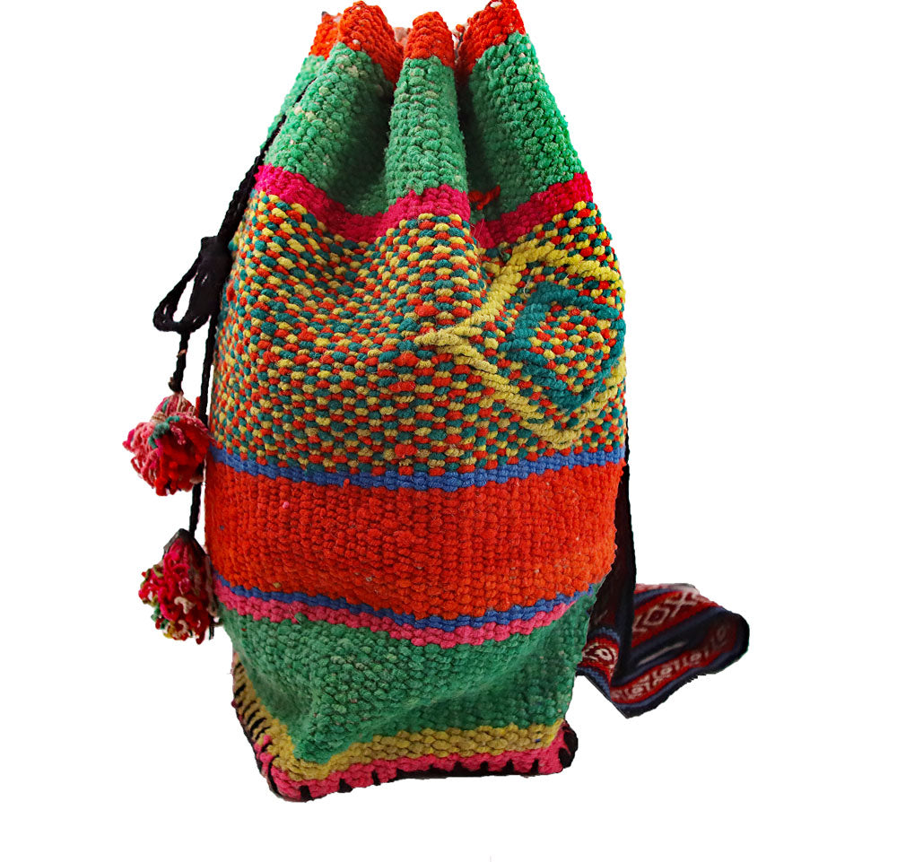 Lagó Spring Green Boho-Style Backpack featuring vibrant colors and geometric designs, handwoven by Quechua artisans.