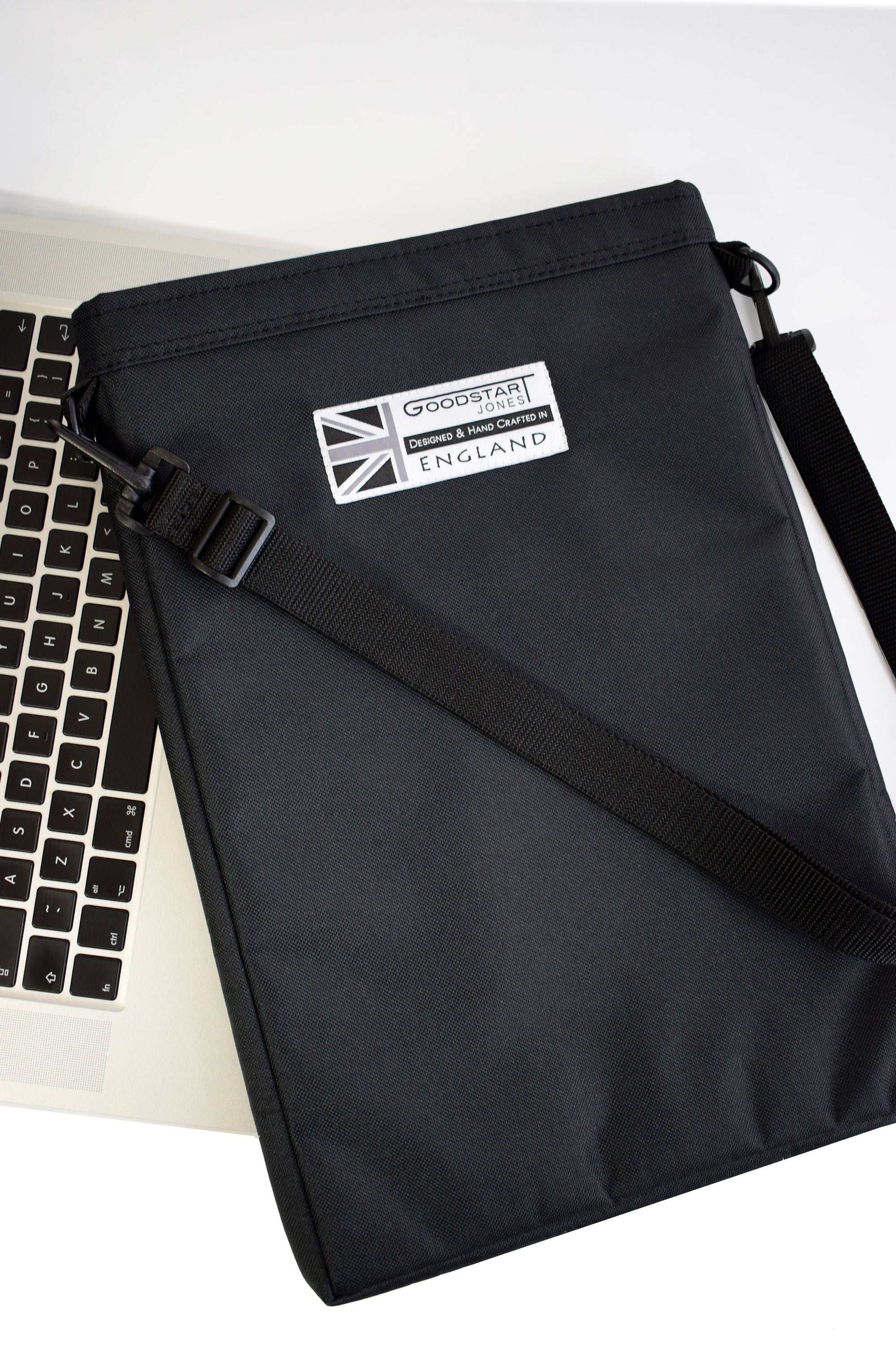 A sleek black laptop carry case designed for 15.6 inch laptops, featuring padded protection and multiple compartments for accessories.