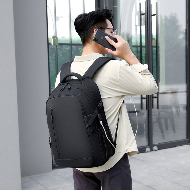 Men's multifunction waterproof backpack with USB charging port, featuring multiple compartments and a stylish design.