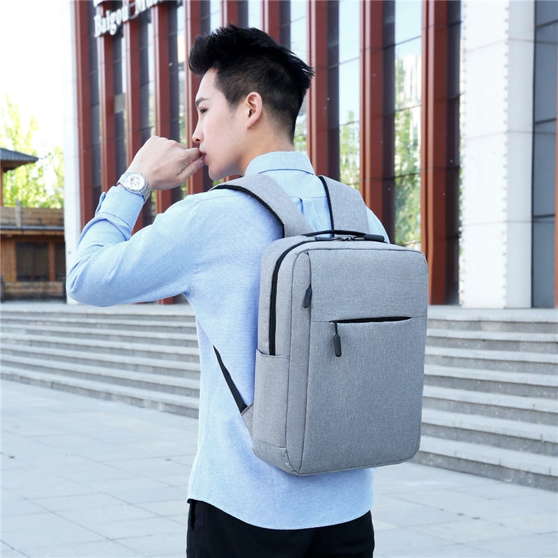 Men's waterproof Oxford cloth backpack with USB charging port, featuring adjustable straps and multiple compartments.