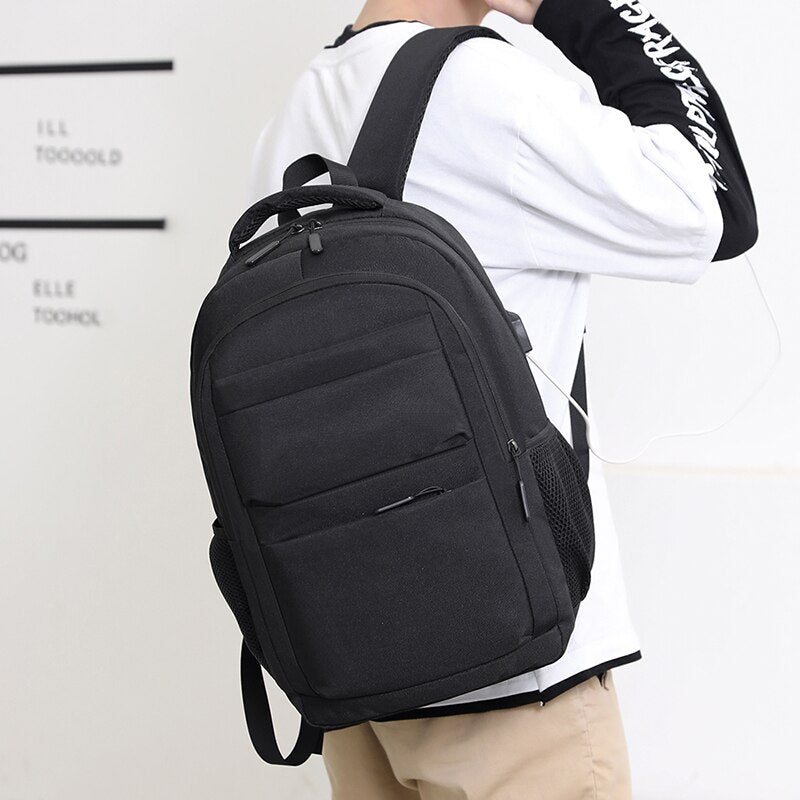 Men's multifunctional waterproof business backpack featuring USB charging port, made of durable nylon with multiple compartments.