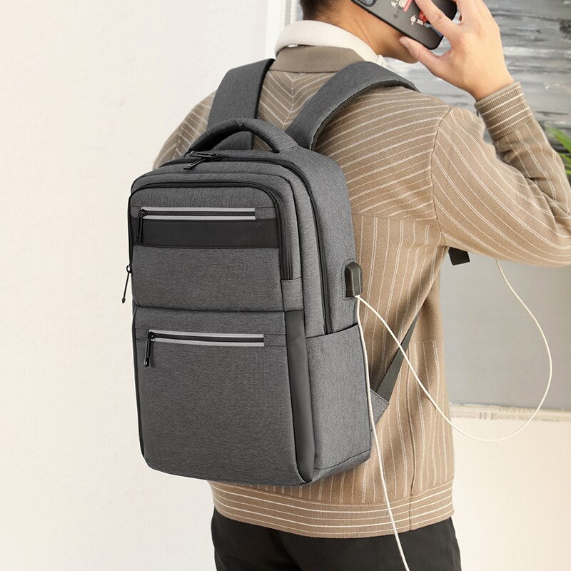 Mens Multifunctional Waterproof Backpack featuring USB charging port, made of durable nylon with multiple pockets and a sleek design.