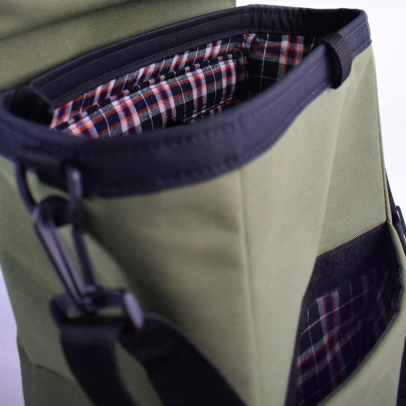 MERCHANT Backpack in Olive Green, showcasing its stylish roll-top design and durable materials.